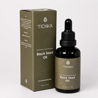 Tichka Black Seed Oil 50 mL bottle with dropper next to its olive green packaging box on a light gray background.