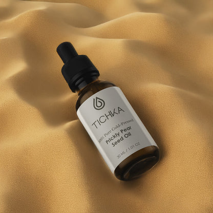 TICHKA bottle of prickly pear seed oil on a beige fabric background