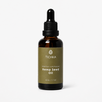 A 50 mL amber glass dropper bottle of Tichka Hemp Seed Oil with a black dropper cap and an olive green label, set against a clean white background.