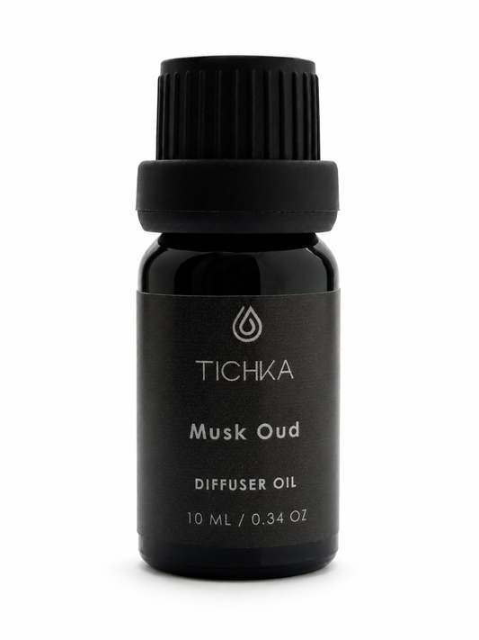 Black bottle of TICHKA Musk Oud diffuser oil on a white background