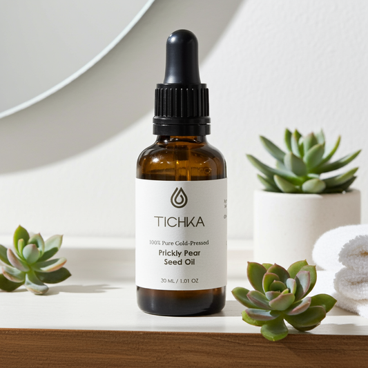 TICHKA prickly pear seed oil bottle with succulents on a wooden surface