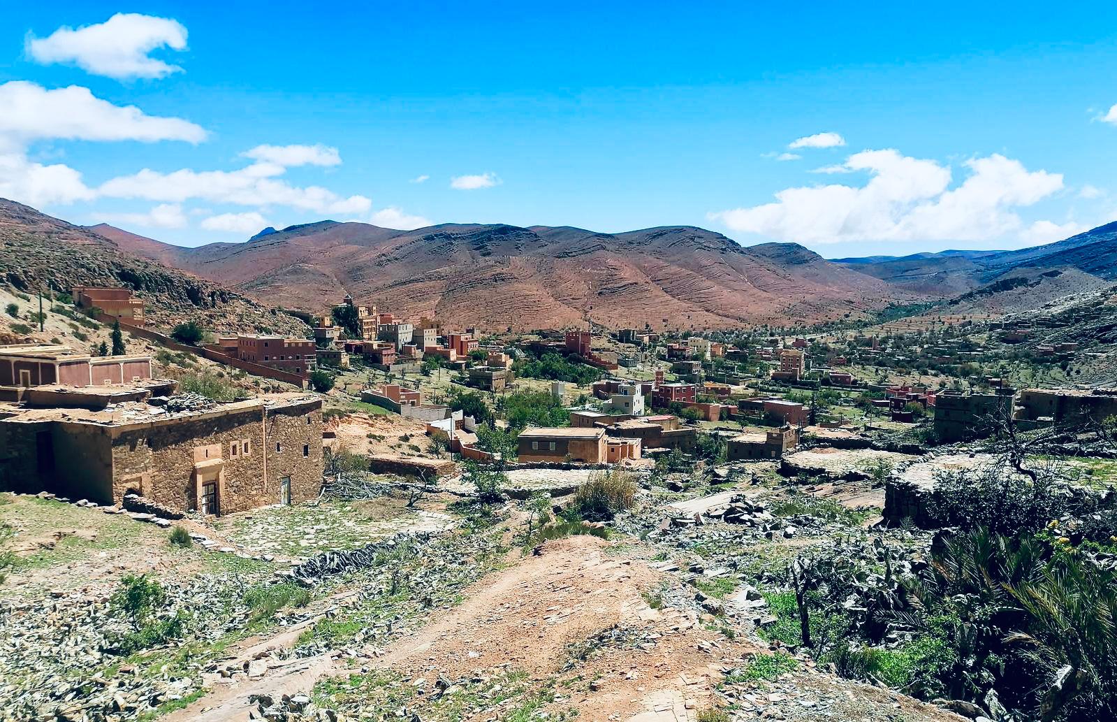 Sidi Mzal Village nestled in a mountainous desert landscape with clear blue sky.