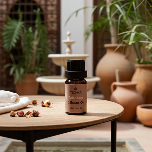 TICHKA Tobacco Diffuser Oil bottle on a wooden table with plants and decorative items in the background